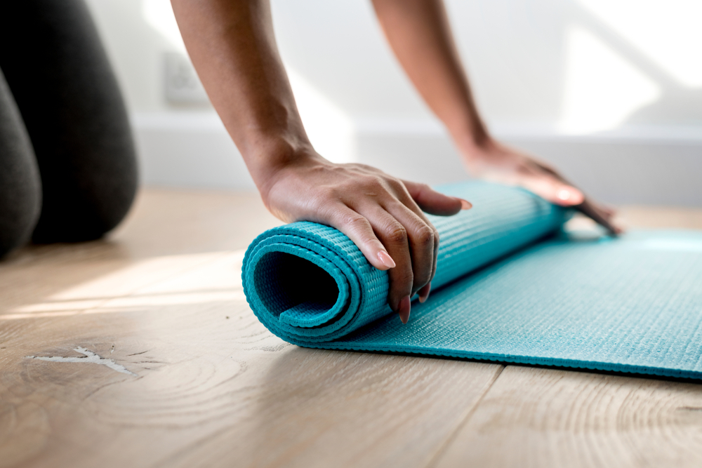 Woman Rolling a Mat