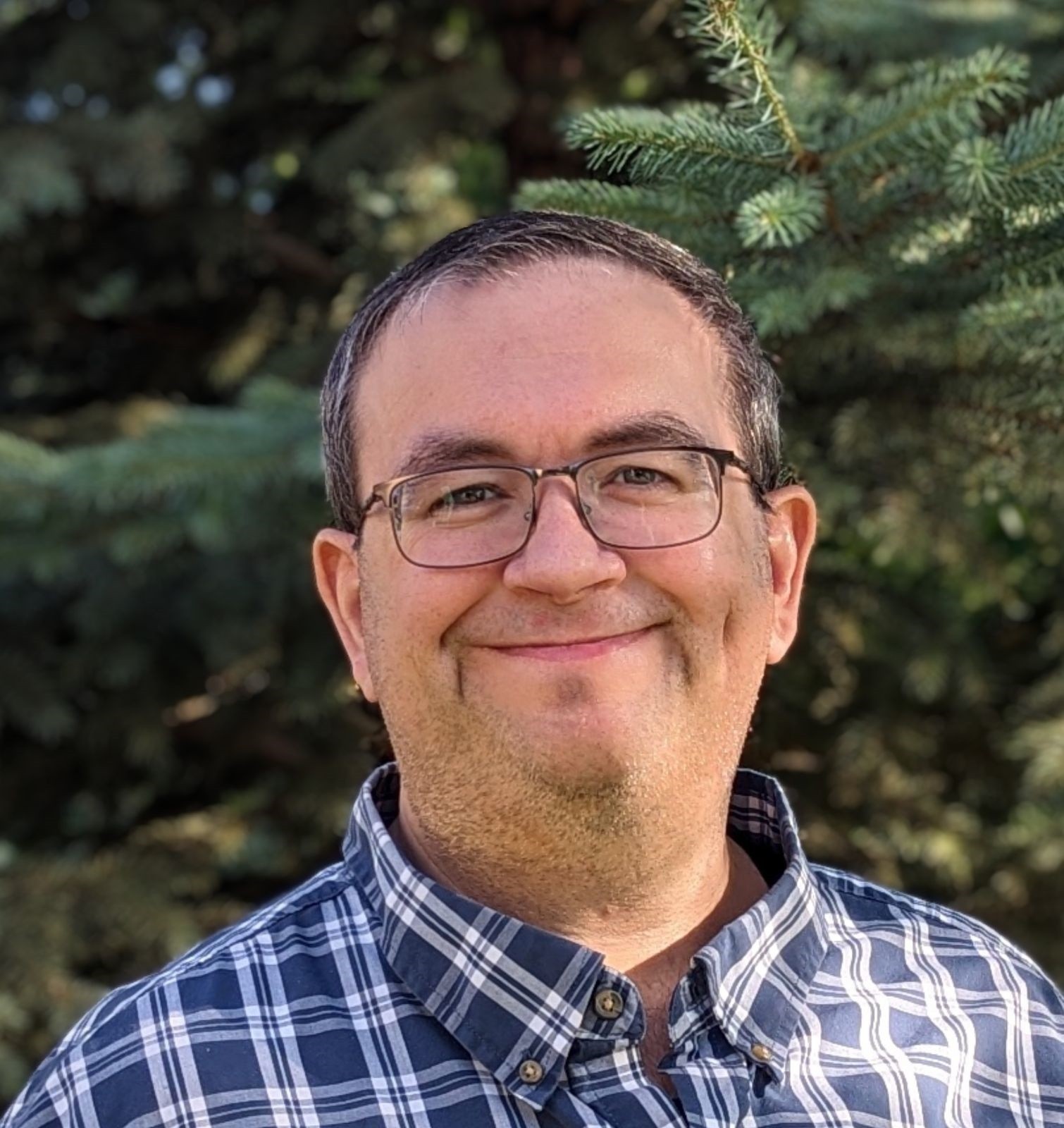 head and shoulders photo of white man with glasses